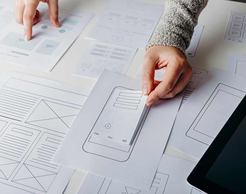 A UX designer working on low-fidelity, paper wireframes