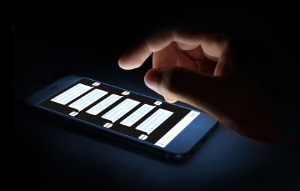 Hand scrolling through texts on smartphone